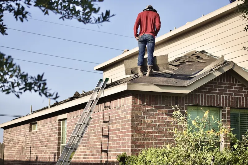 Professional roofer working on a residential roof in Penn Oak Manor